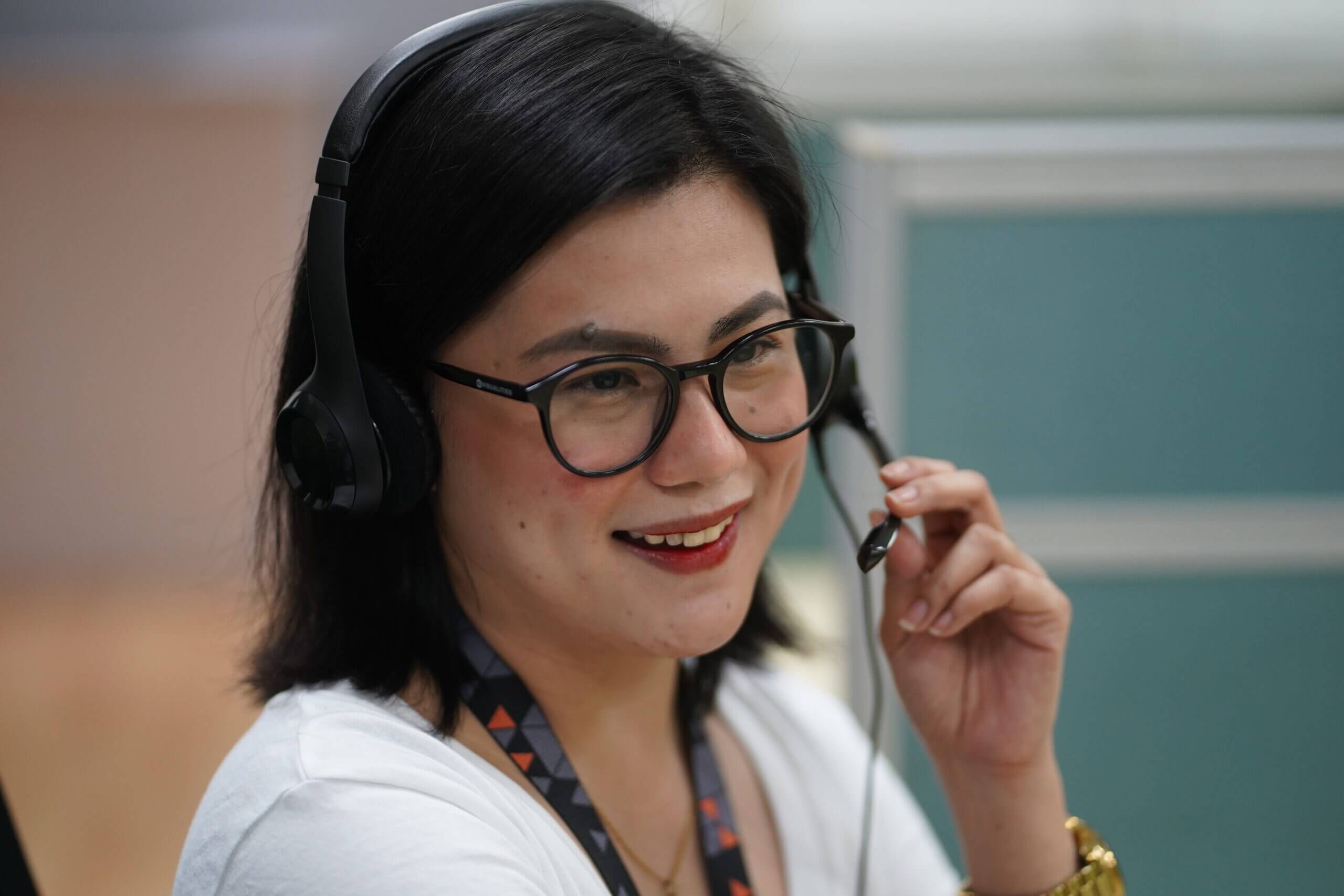 A woman with a headset providing customer care support