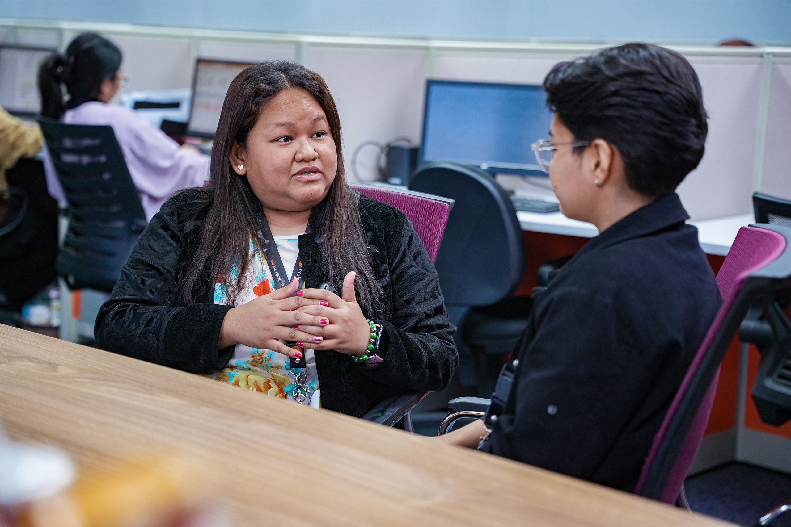 Two colleagues talking in an office